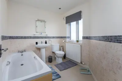 a bathroom with a tub and a toilet and a sink at Spacious Luxurious Serviced Accommodation 6 in Barrow in Furness
