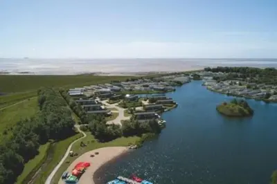an aerial view of a group of houses in a lake at Lakeside location, sleeps 8, 3 bedrooms, fully glazed wrap around decking, Haven Lakeland, Lake District in Flookburgh