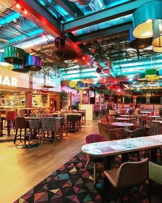 a restaurant with tables and chairs in a room at Lakeside location, sleeps 8, 3 bedrooms, fully glazed wrap around decking, Haven Lakeland, Lake District in Flookburgh