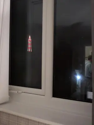 a window with a red and white sign on it at Nathans in Blackpool