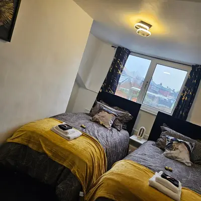 a bedroom with two beds and a window at West park Royal House, Holidays, Contractors,Relocation,Free Parking & WiFi in Preston