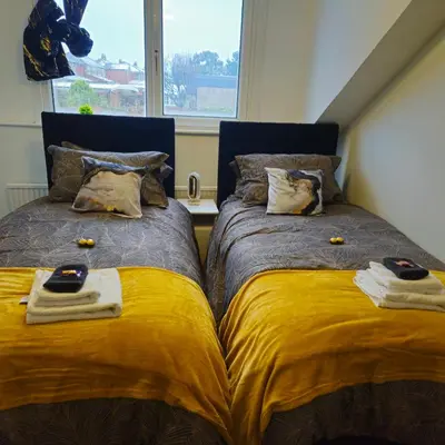 two beds sitting next to each other in a bedroom at West park Royal House, Holidays, Contractors,Relocation,Free Parking & WiFi in Preston