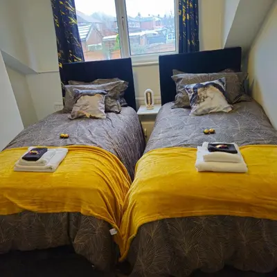 two beds sitting next to each other in a bedroom at West park Royal House, Holidays, Contractors,Relocation,Free Parking & WiFi in Preston