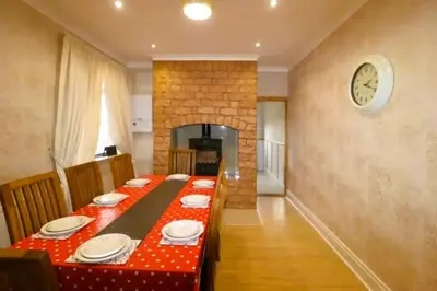 a dining room table with a red and white table cloth at 4 Bed House Sleeps 8 - Pet Friendly with Garden in Blackpool
