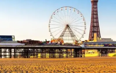 a ferris wheel and a pier with a tower at 4 Bed House Sleeps 8 - Pet Friendly with Garden in Blackpool