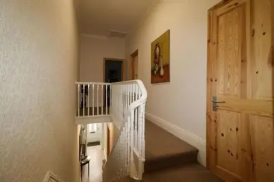 a white spiral staircase in a room with a door at 4 Bed House Sleeps 8 - Pet Friendly with Garden in Blackpool