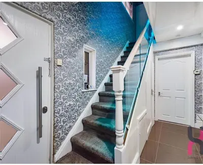a staircase in a house with a blue wall at house with hot tub in West Derby