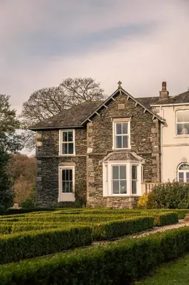 a large stone house with a yard at Cartmel Old Grammar in Cartmel