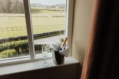 a window sill with a container and a wine glass at Cartmel Old Grammar in Cartmel