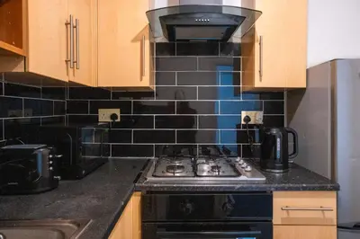 a kitchen with a stove top oven in a kitchen at Kirkdale Apartment in Liverpool