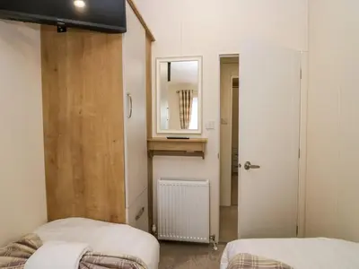 a small room with two beds and a mirror at Lakeland Lodge- 3Bed-2 Bath- Private Patio in Carnforth