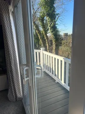 a door to a balcony with a view of a porch at Getaway in Longridge