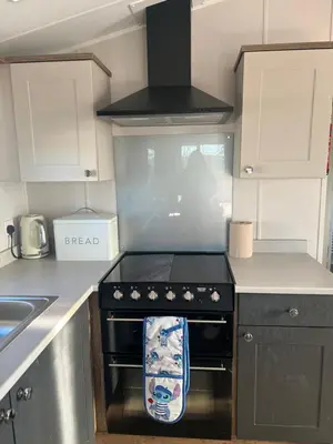 a kitchen with a black stove top oven next to a sink at Getaway in Longridge