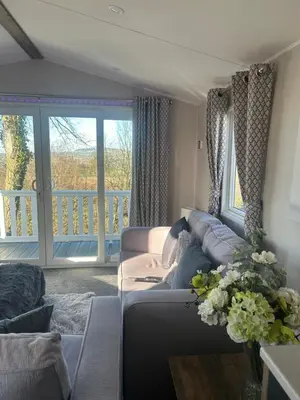 a living room with a couch and a balcony at Getaway in Longridge