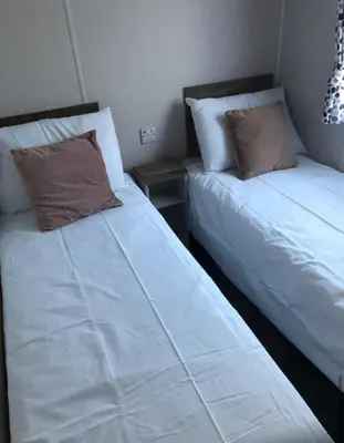 two beds sitting next to each other in a room at Getaway in Longridge