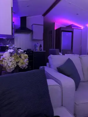 a living room with a white couch and purple lights at Getaway in Longridge