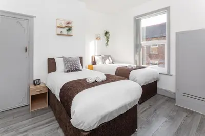 a bedroom with two beds and a window at Fairburn House - Air Host & Stay - Contractor Friendly in Liverpool
