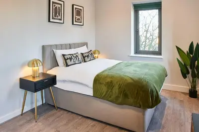 a bedroom with a bed with a nightstand and a window at Host & Stay - Mariposa Waterloo in Sefton