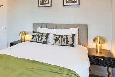 a bedroom with a large white bed with two lamps at Host & Stay - Mariposa Waterloo in Sefton