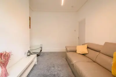 a living room with a couch and a table at Modern House Blackburn in Blackburn