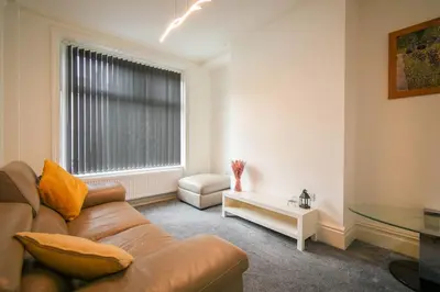 a living room with a couch and a glass table at Modern House Blackburn in Blackburn