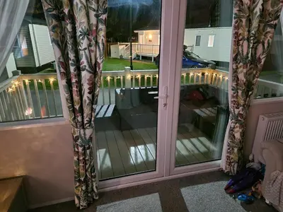 a sliding glass door with a view of a balcony at Lakeland Leaisure park Haven Caravan in Flookburgh