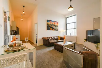 a living room with a couch and a table at Suite in the center of Great Harwood in Great Harwood
