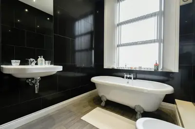 a bathroom with a white tub and a sink at Suite in the center of Great Harwood in Great Harwood