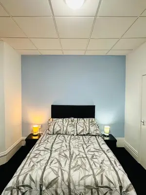 a bedroom with a bed and two lamps on tables at Shokal Nest in Blackpool