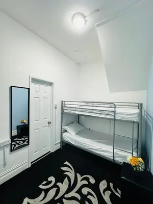 a bedroom with a bunk bed and a mirror at Shokal Nest in Blackpool