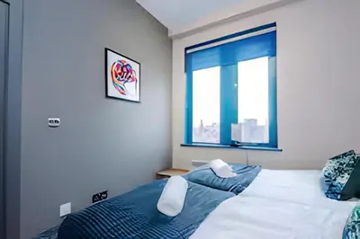 a bedroom with a bed and a window at 1 Bedroom Apartment in Wigan Town Centre With Free Parking, by Short Term Digs Short Lets & Serviced Accommodation in Wigan