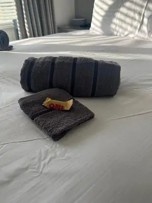 a blanket on a bed with a one piece of food at Stylish Home Away From Home! 6 Minutes from Beach! in Wirral