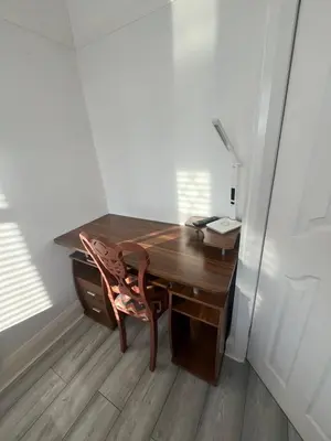 a wooden desk with a chair in a room at Stylish Home Away From Home! 6 Minutes from Beach! in Wirral