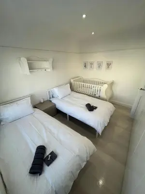 two beds in a room with shoes on them at Stylish Home Away From Home! 6 Minutes from Beach! in Wirral