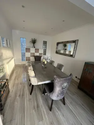 a living room with a dining room table and chairs at Stylish Home Away From Home! 6 Minutes from Beach! in Wirral