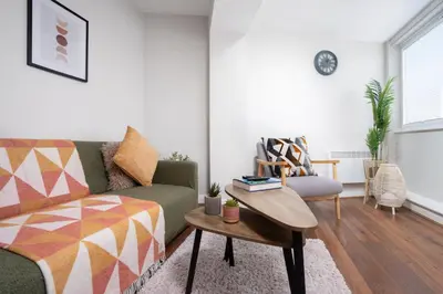 a living room with a couch and a table at Cozy Waterfront Apartment - Free Parking & Wi-Fi in Preston