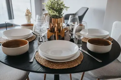 a black table with plates and bowls on it at Dockside Escape By Royal Albert Dock in Liverpool