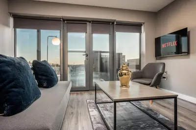 a living room with a couch and a table at Dockside Escape By Royal Albert Dock in Liverpool