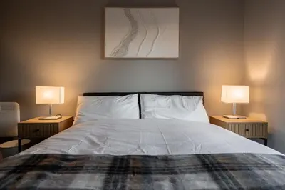 a bedroom with a bed with two lamps on both sides at Dockside Escape By Royal Albert Dock in Liverpool