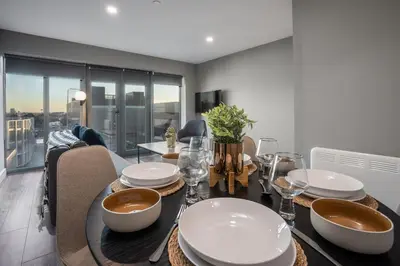 a dining room with a table with bowls and plates on it at Dockside Escape By Royal Albert Dock in Liverpool