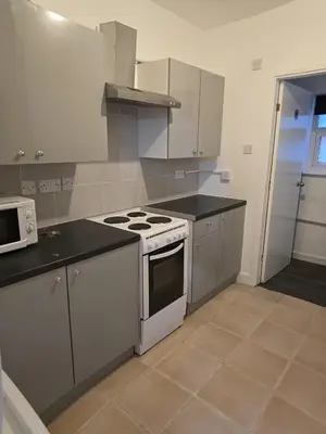 a kitchen with a stove and a microwave in it at 167,ormskirk road in Wigan