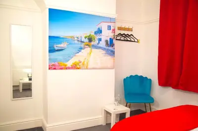 a bedroom with a painting of a beach at Lucky Home 7 - Ideal for Trade & Family - 2 Bedrooms - 2 Beds - Max 4 Guests - Close to BAE, Docks, Lake District, Beaches in Barrow in Furness