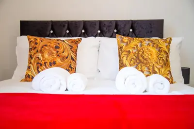 a bed with three rolls of towels on it at Lucky Home 15 - Ideal for Trade & Family - 2 Bedrooms - 2 Beds - Max 4 Guests - Close to BAE, Docks, Lake District, Beaches in Barrow in Furness