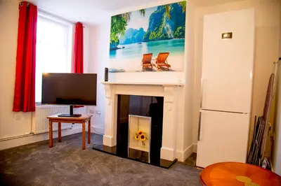 a living room with a fireplace and a tv at Lucky Home 15 - Ideal for Trade & Family - 2 Bedrooms - 2 Beds - Max 4 Guests - Close to BAE, Docks, Lake District, Beaches in Barrow in Furness