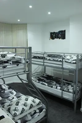 a room with three bunk beds in a room at The Moray House in Blackpool