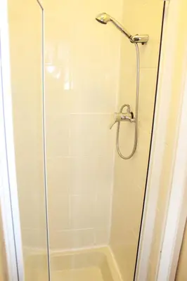 a shower with a glass door in a bathroom at The Moray House in Blackpool