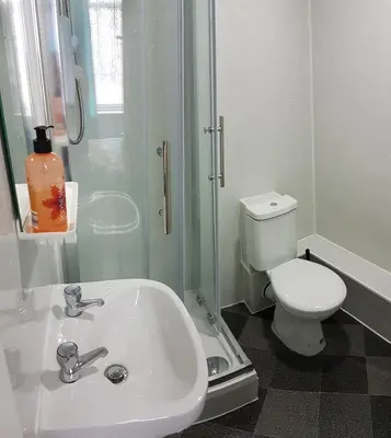 a bathroom with a sink and a shower and a toilet at The Moray House in Blackpool