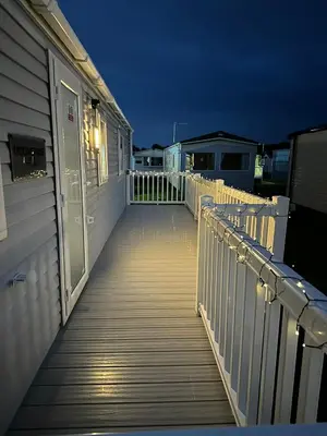 a boardwalk leading down to a house at night at Caravan to Hire - CalaGran Fleetwood Blackpool in Fleetwood