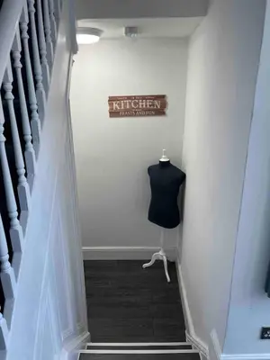 a stairway with a mannequin and a sign on a wall at Flat1 Large modern King Bed flat, private bedroom Ryan's place in Walton on the Hill