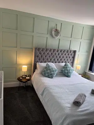 a bedroom with a large bed with two pillows at Flat1 Large modern King Bed flat, private bedroom Ryan's place in Walton on the Hill